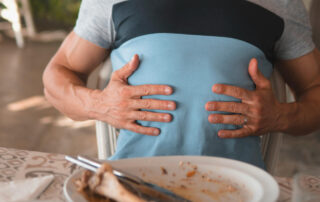 A man with digestive issues holding his gut