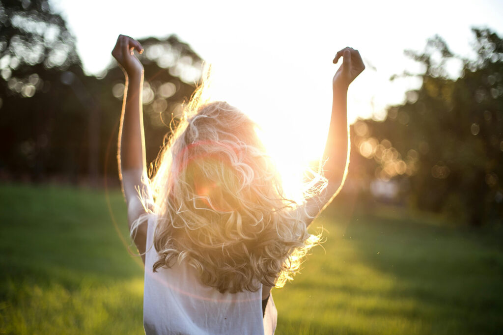 A woman with Perimenopause running in a natural healing field