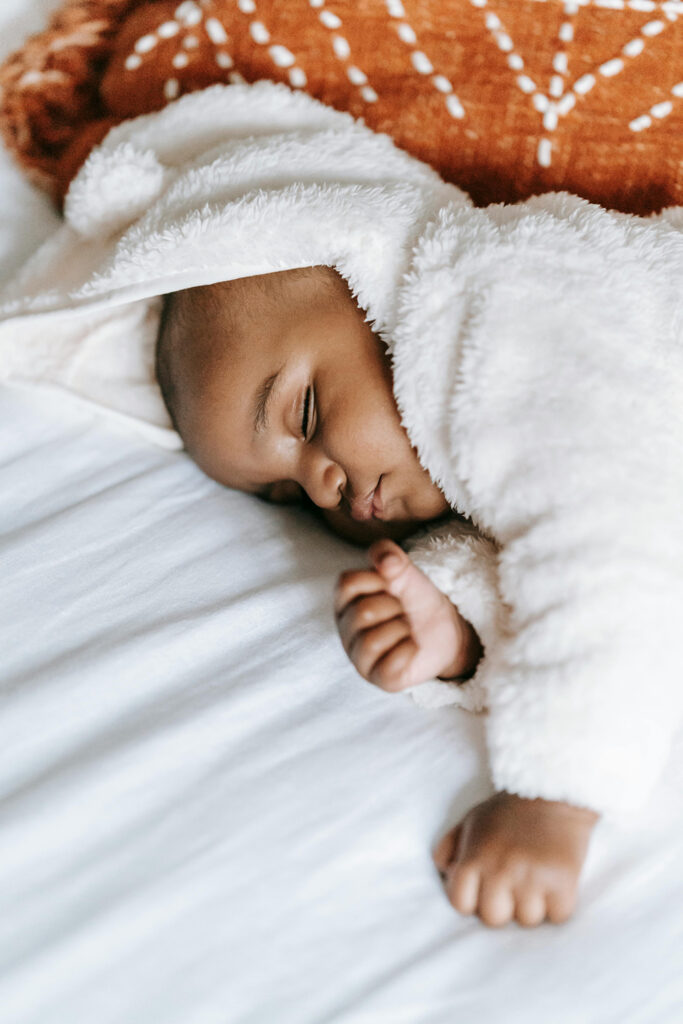 a baby sleeping on Organic Mattress and Bedding