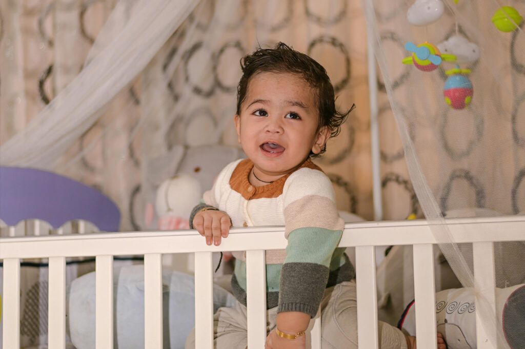 A toddler in a crib in a holistic nursury