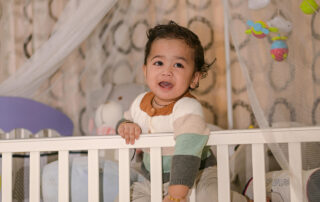 A toddler in a crib in a holistic nursury