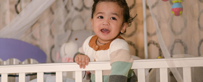 A toddler in a crib in a holistic nursury