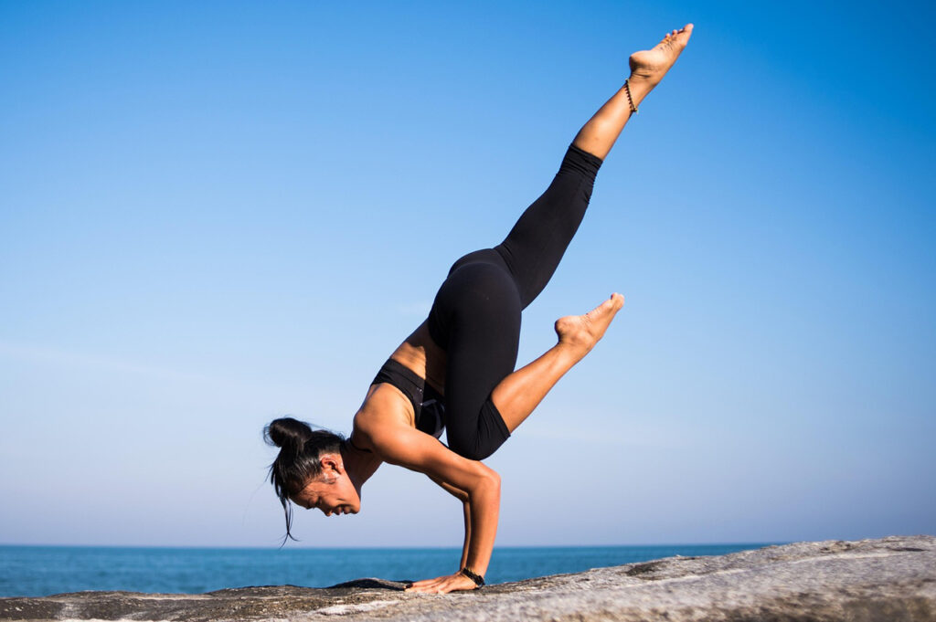 A woman doing yoga on the beach