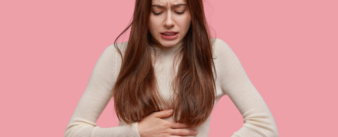 a woman with gerd and heartburn needing holistic support in Charleston, SC